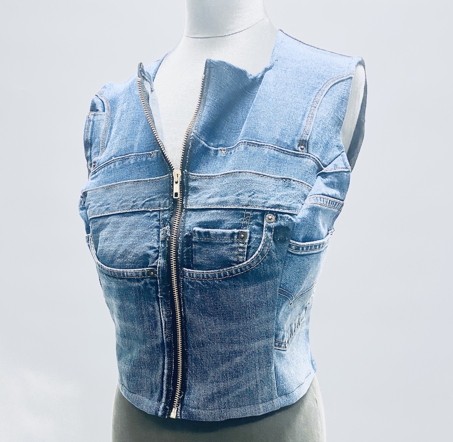 The Bustier Vest is on a mannequin. Made upcycled out of denim.